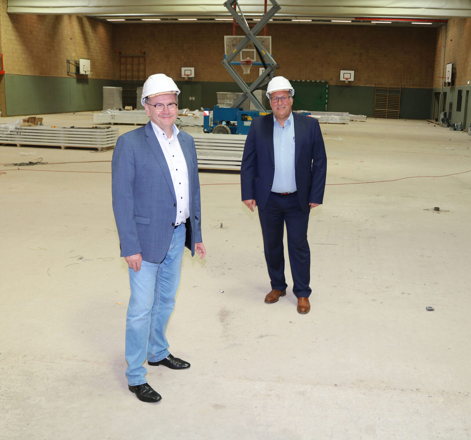 Landrat Uwe Schmidt (links) und Bürgermeister Manfred Ludewig bei der Besichtigung der Sanierungsarbeiten in der Großsporthalle in Vellmar.
