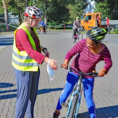 Geflüchtete Frauen aus unterschiedlichen Ländern lernen auf dem Parkplatz der Albert-Schweitzer-Schule in Hofgeismar das Radfahren.